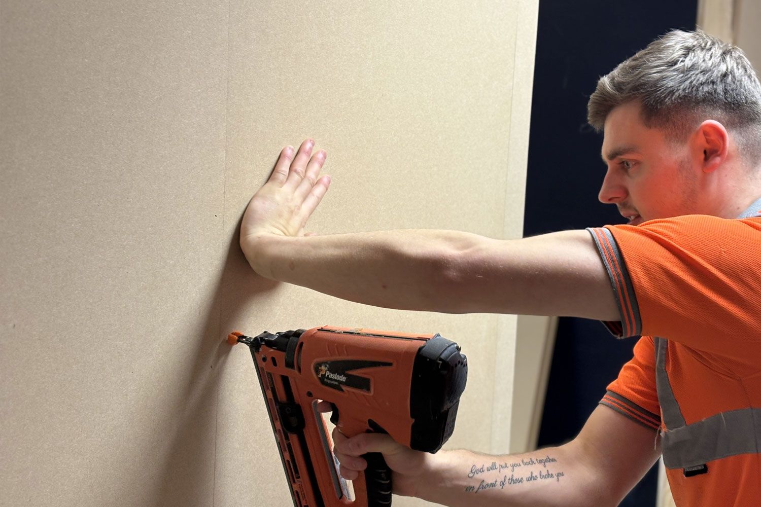 team member using nail gun